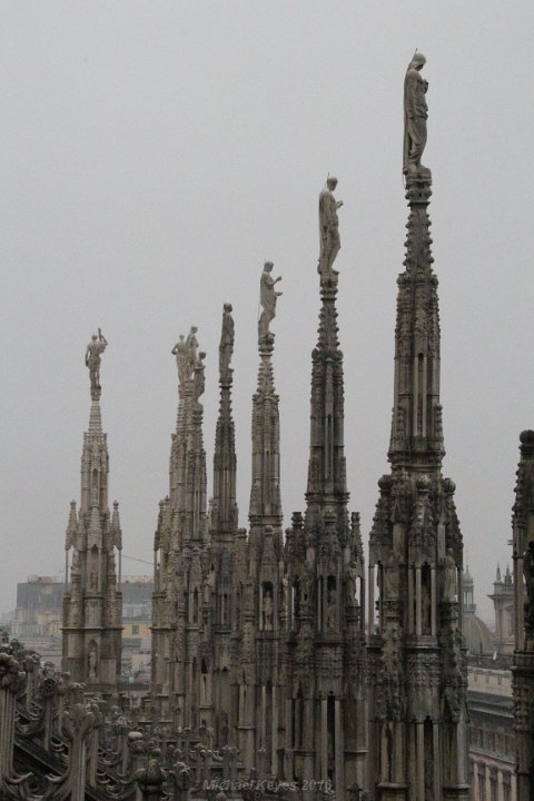 IMG_1978.JPG - Hundreds, of these statues adorn the duomo, in this case they're stacked like a gem encrusted piece of jewlry!   I imagine with enough money you can buy a spire of your own. 