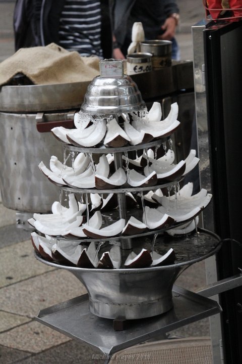 IMG_2018.JPG - Coconut pyramid water fall fountain... Looks like a Christmas tree..   I've seen these all over the world... Very cool idea... on a hot day. 